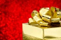 Close up Golden present box with big bow at bokeh white blur background, Leave space on top to adding your content Royalty Free Stock Photo